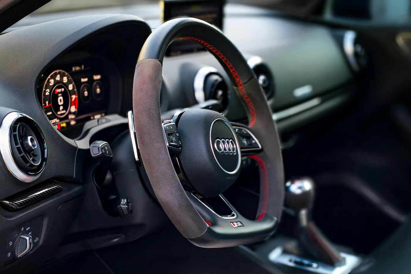 Close-up of steering wheel and dashboard showing modern car interior controls