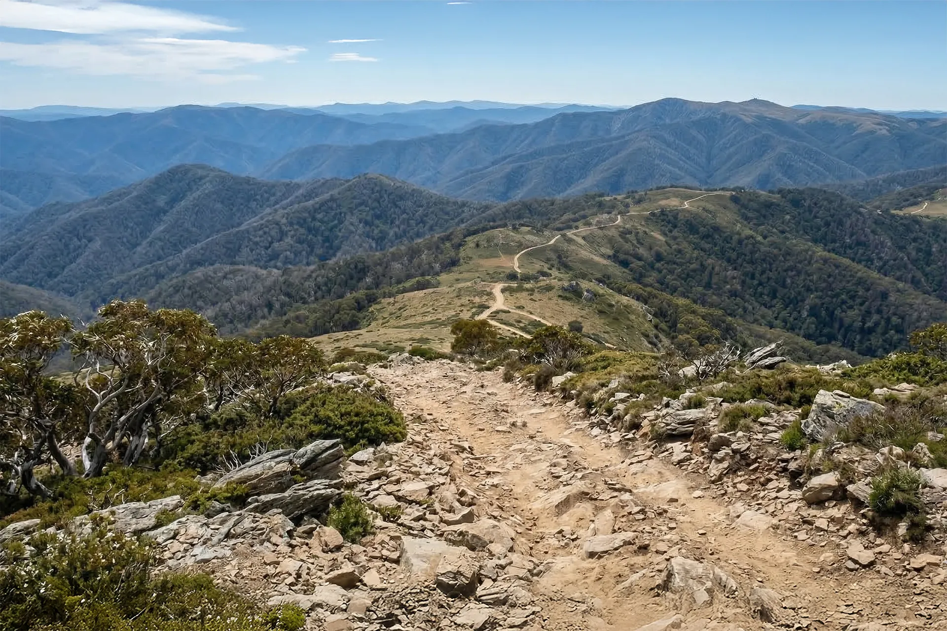 Rocky section of Blue Rag Range Track overlooking the mountainous landscape of the Victorian High Country in Australia.