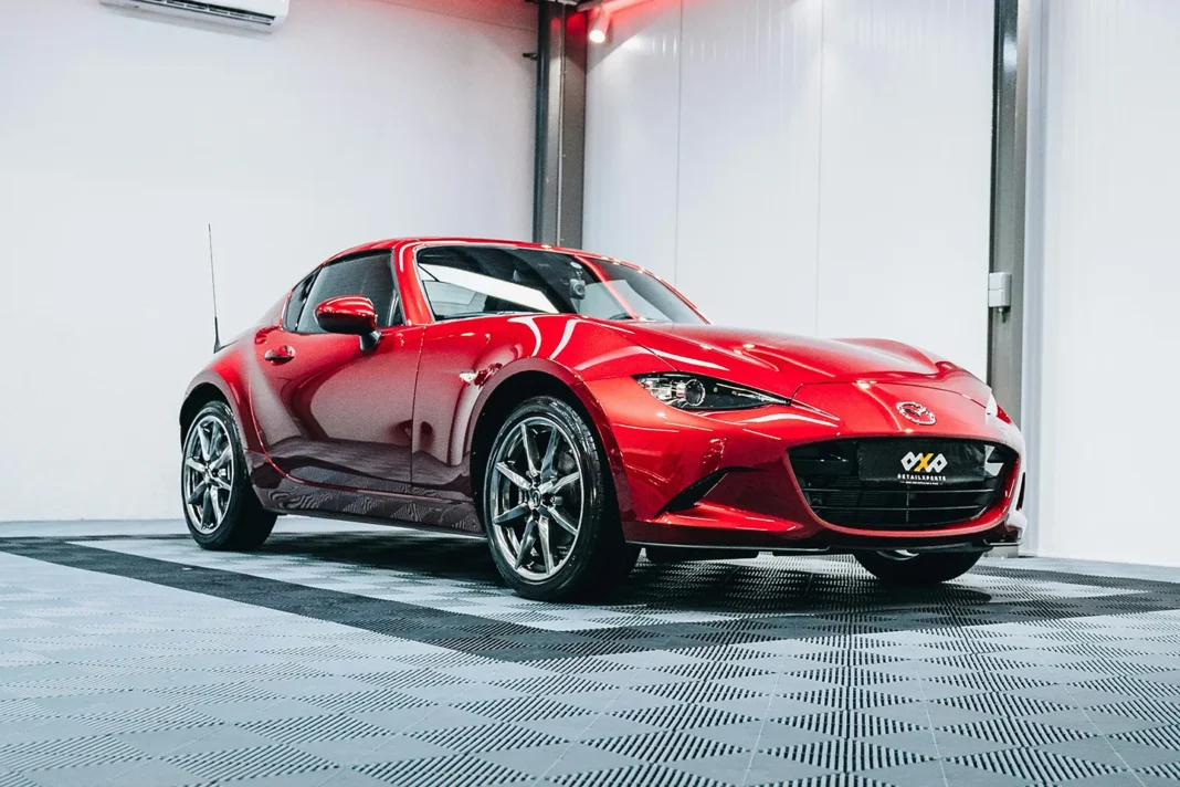 car-detailing-finished-polished-paint red sports car with freshly detailed paint in professional detailing studio