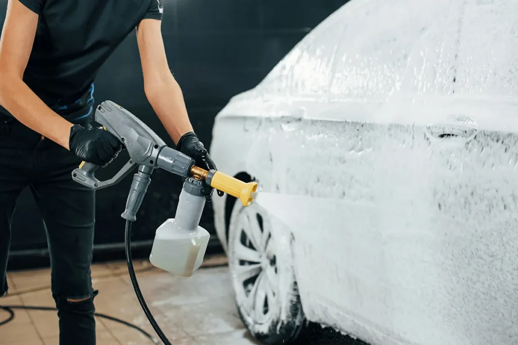 foam cannon spraying snow foam onto car during pre wash