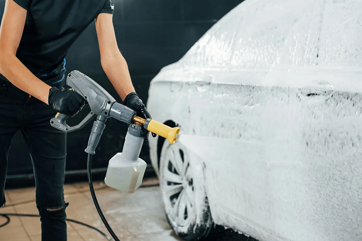 foam cannon spraying snow foam onto car during pre wash