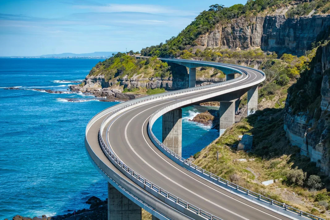 grand-pacific-drive-sea-cliff-bridge-nsw-coastal-road Aerial-style view of Sea Cliff Bridge along the Grand Pacific Drive with ocean and cliffs in NSW