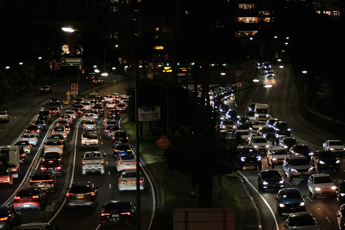 Heavy traffic congestion with cars lined up on a busy multi-lane road in an Australian city at night