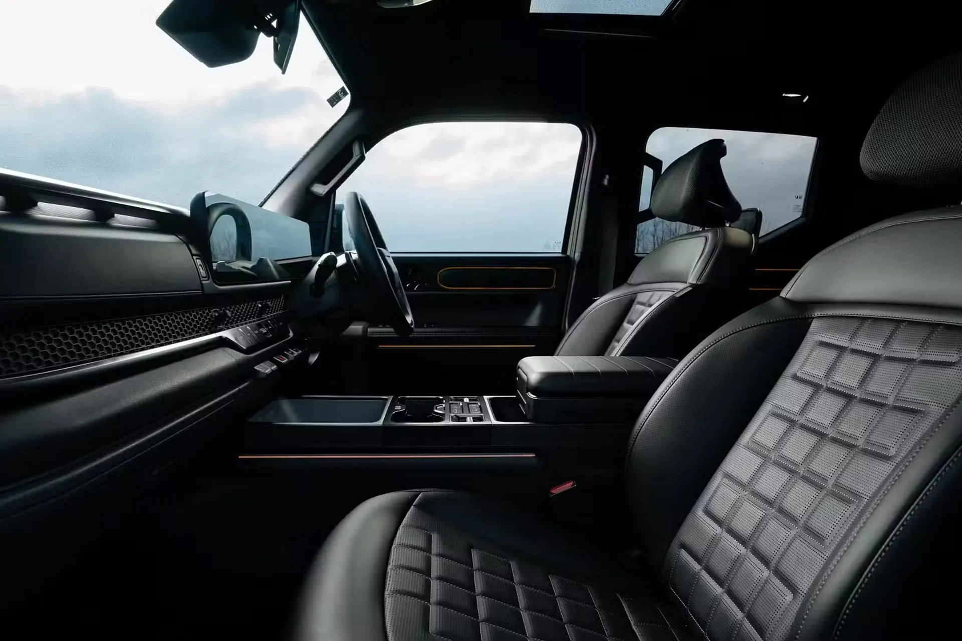 Front seats and cabin interior of the Kia Tasman ute featuring premium materials and modern dashboard layout.