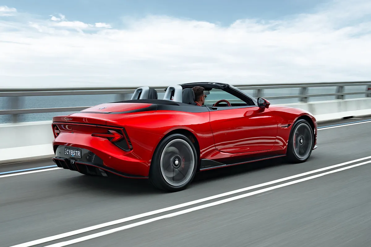 MG Cyberster GT rear view driving on coastal road in Australia with top down