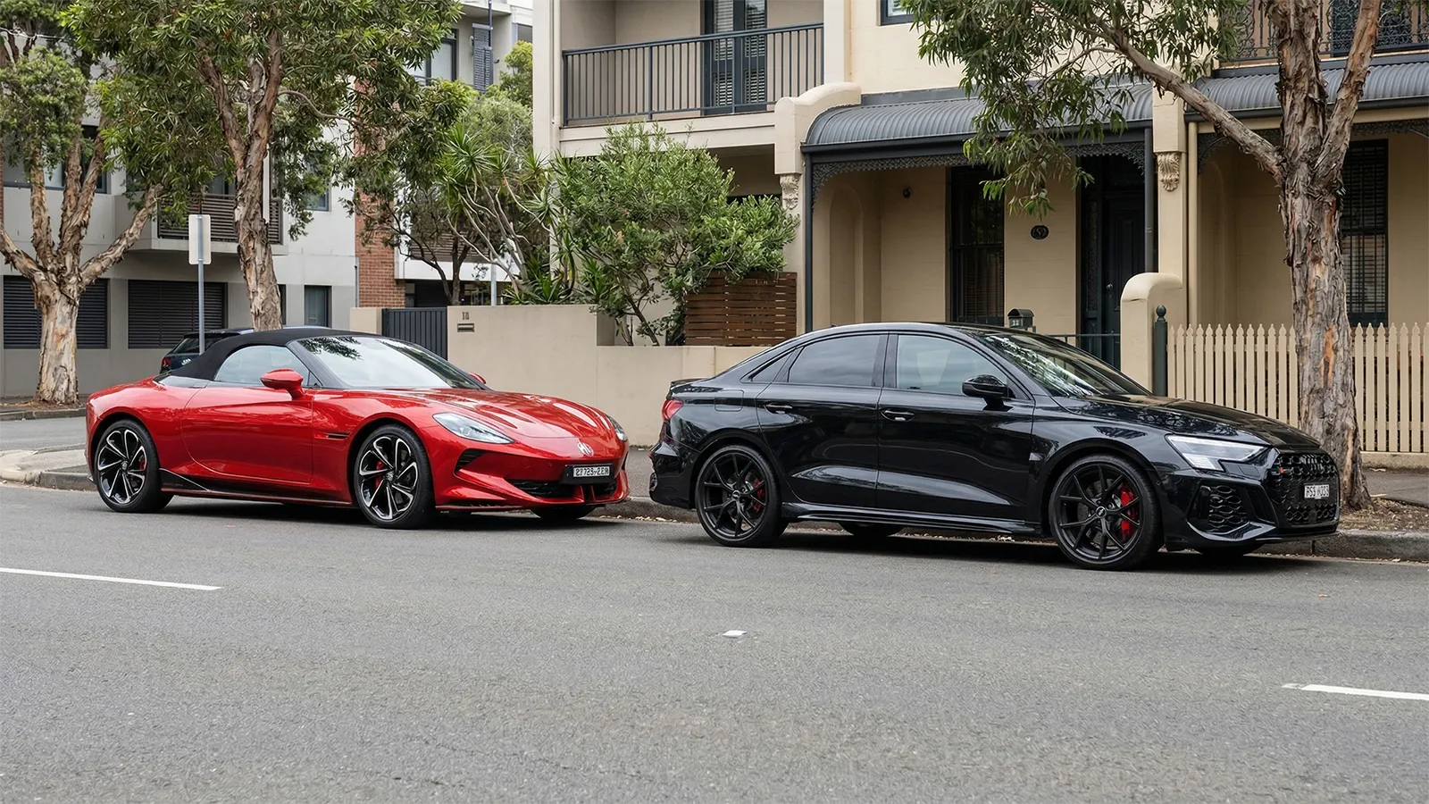 MG Cyberster GT and Audi RS3 Sedan parked in urban street showing design differences