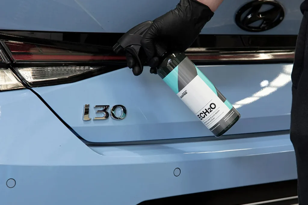 spray detailing product applied to car paint protection