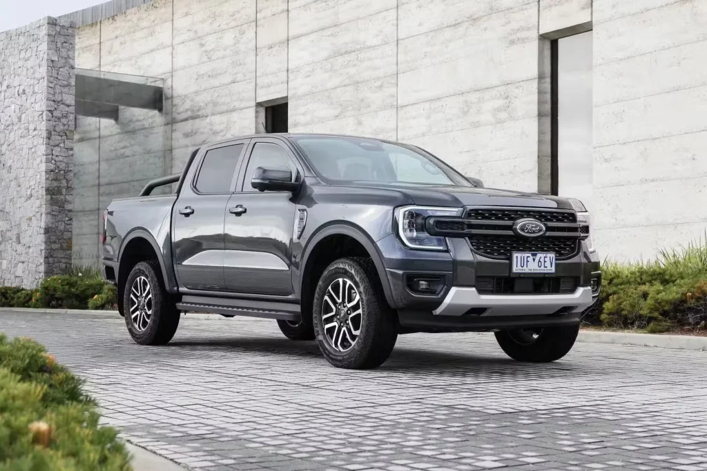 mid size SUV parked outside modern building representing the typical cost of owning an SUV in Australia