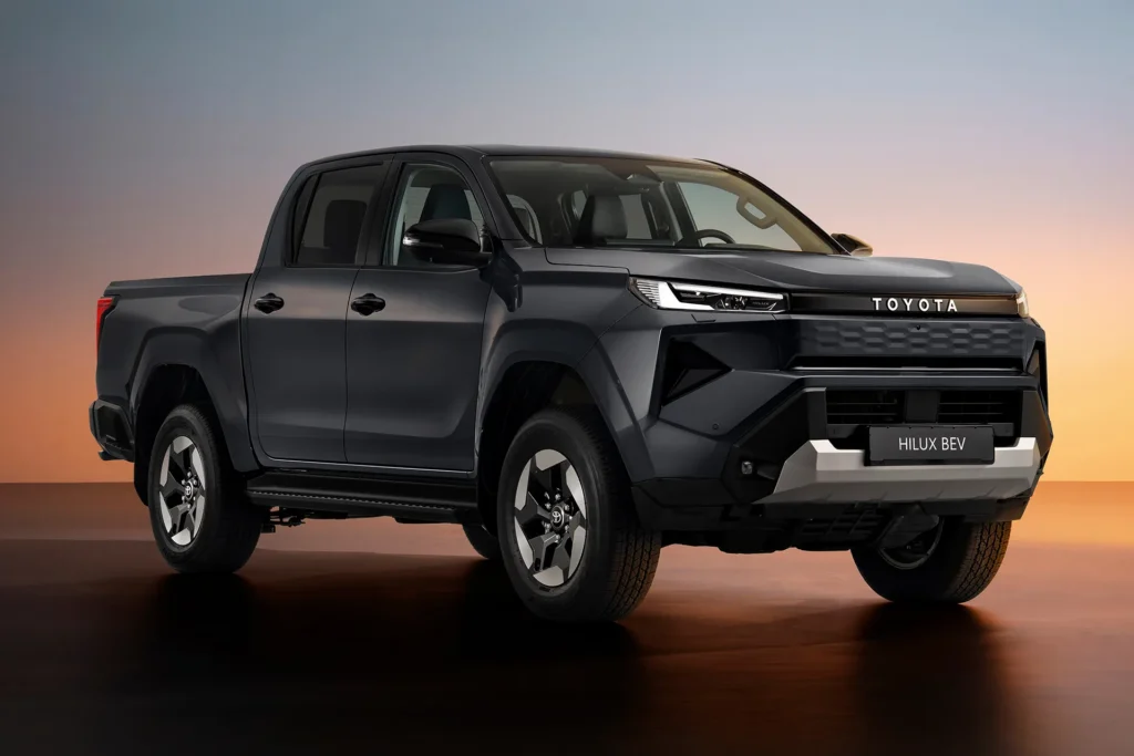 Front three-quarter view of the Toyota Hilux BEV electric pickup truck highlighting the bold grille design and rugged styling.