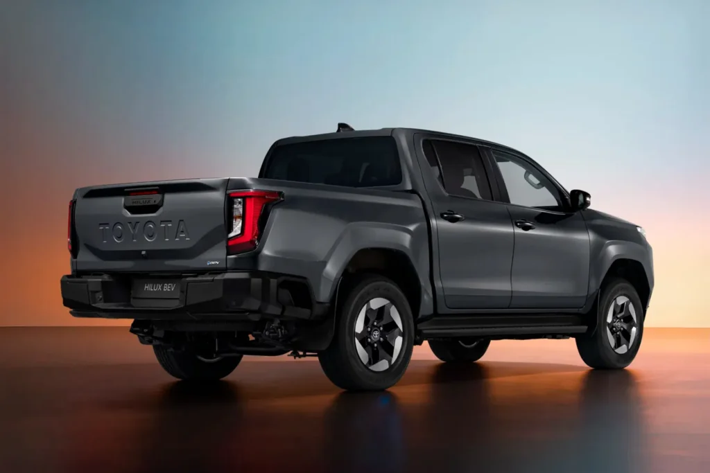 Rear three-quarter view of the Toyota Hilux BEV electric pickup truck showing tailgate design and LED taillights.