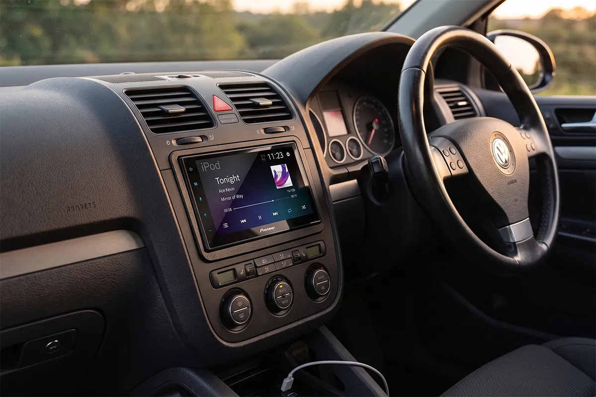 pioneer-sph-da360dab-headunit-vw-golf-mk5-dashboard.webp Alt text: Pioneer SPH-DA360DAB head unit playing music in VW Golf Mk5 dashboard at sunset