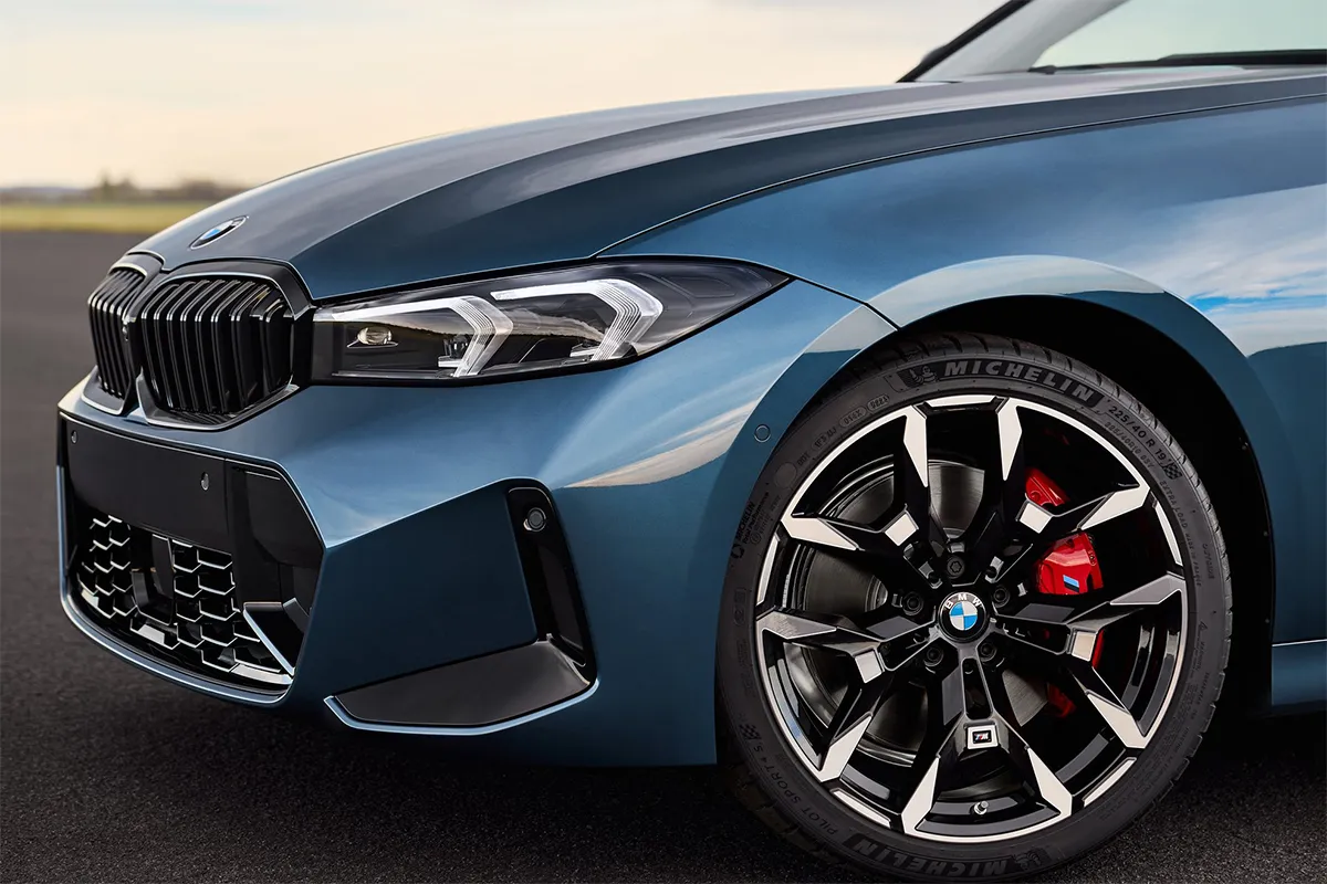 Close-up of the 2026 BMW 330i M Sport showing the 19-inch alloy wheel, Michelin Pilot Sport tyre, and red M Sport brake caliper