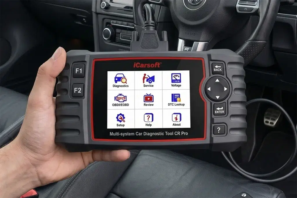 iCarsoft CR Pro multi-system diagnostic scanner displaying its main menu inside a vehicle cabin