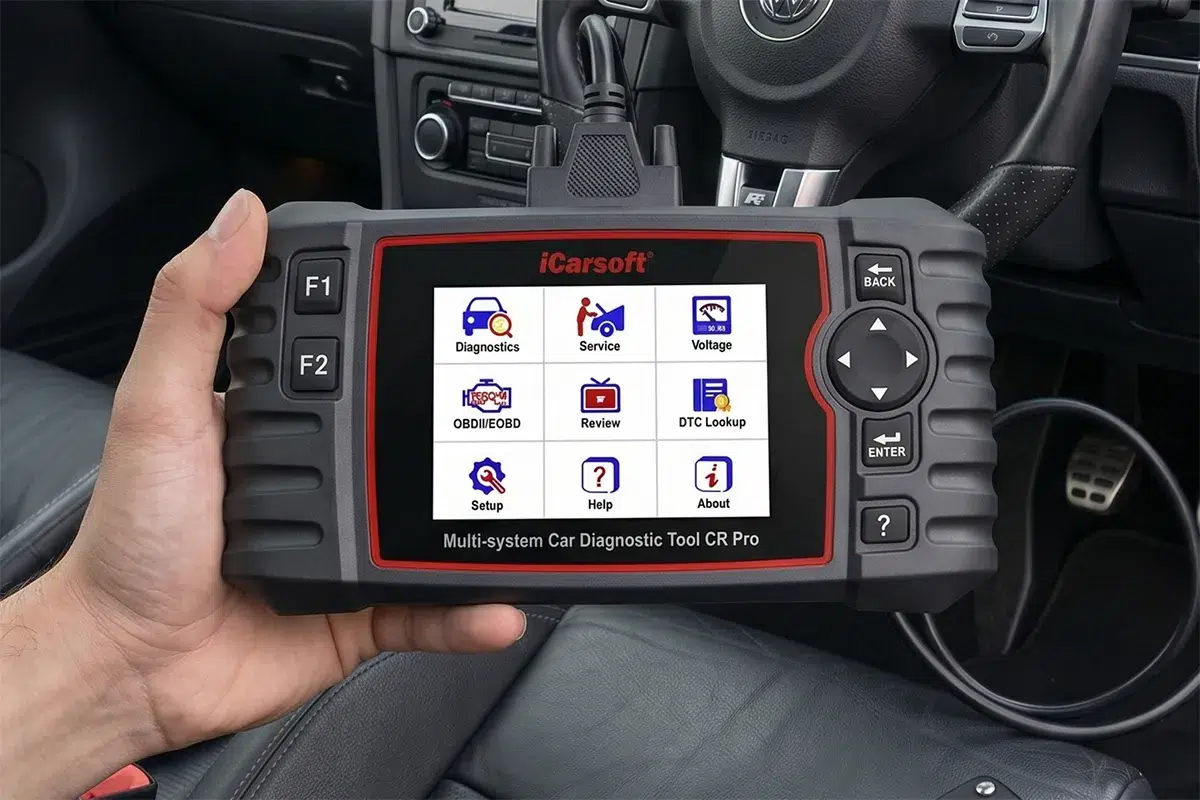 iCarsoft CR Pro multi-system diagnostic scanner displaying its main menu inside a vehicle cabin