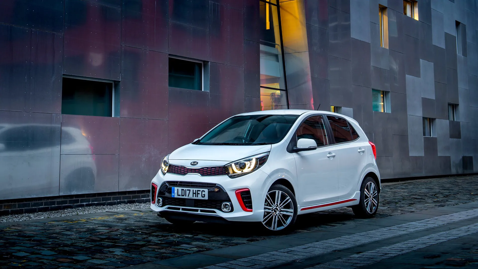kia-picanto-gt-line-budget-hatchback White Kia Picanto GT-Line parked on a cobbled urban street, representing the era of sub-$20,000 budget hatchbacks now gone from Australian showrooms