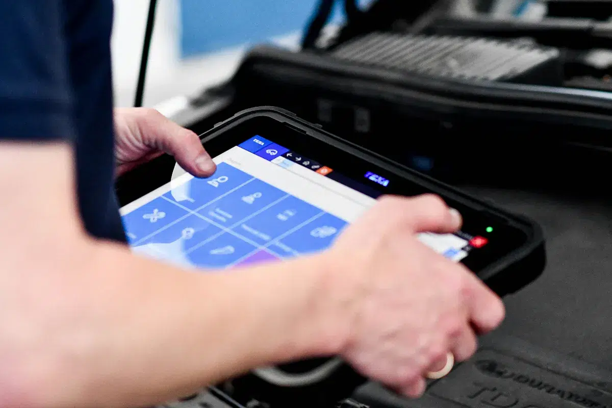 Mechanic using a professional diagnostic tablet in an Australian workshop