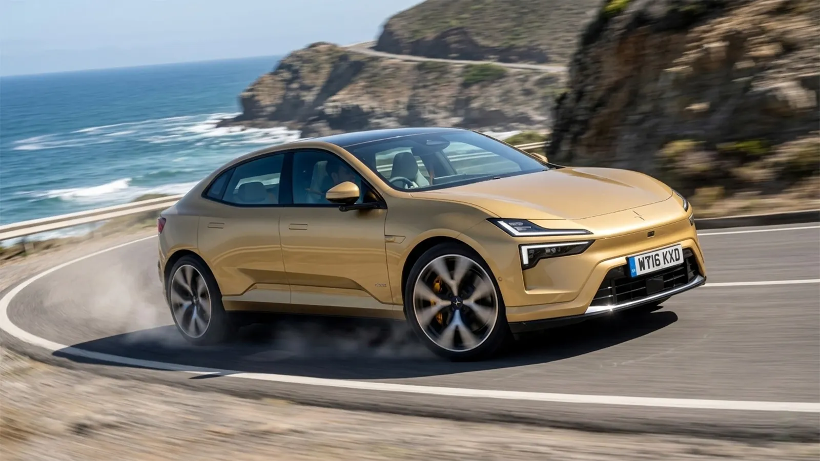 Polestar 4 cornering on a coastal road with ocean cliffs in the background showing dynamic driving stance