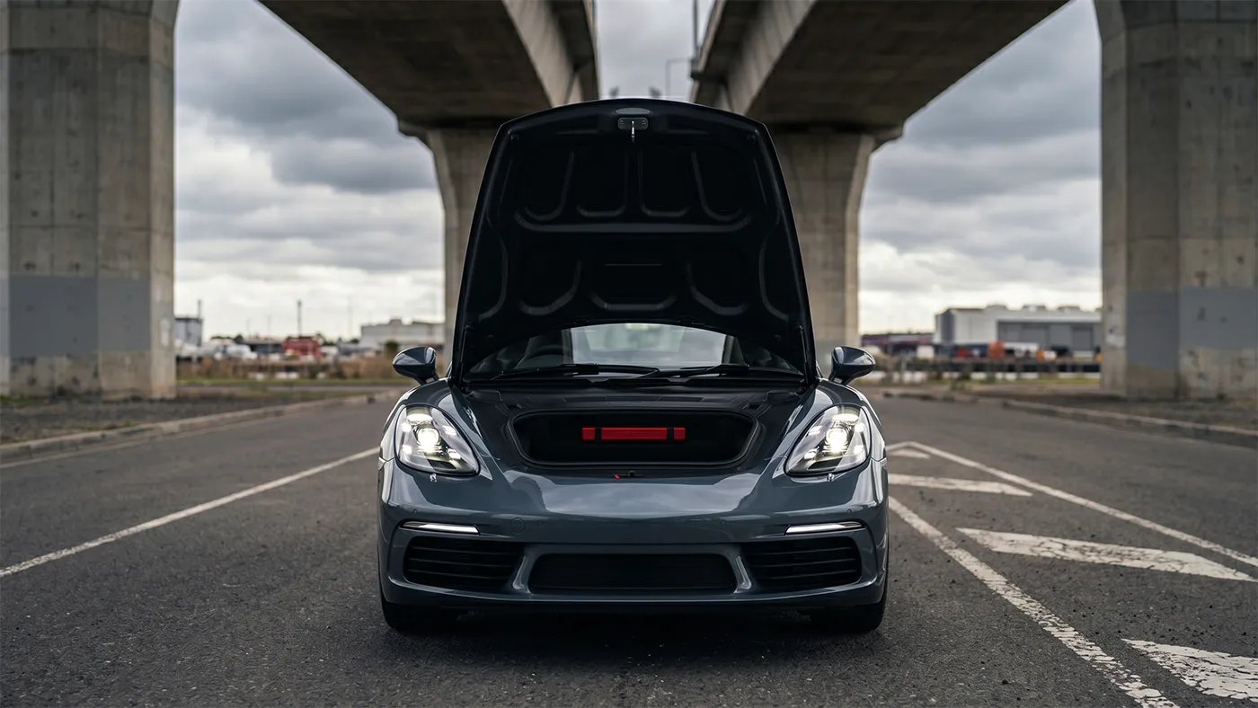 2026 Porsche 718 Cayman with the front bonnet open showing the empty front luggage compartment
