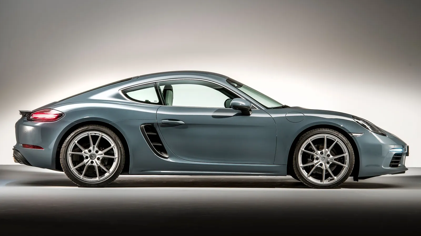 Side profile of the 2026 Porsche 718 Cayman showing the classic Porsche silhouette and proportions