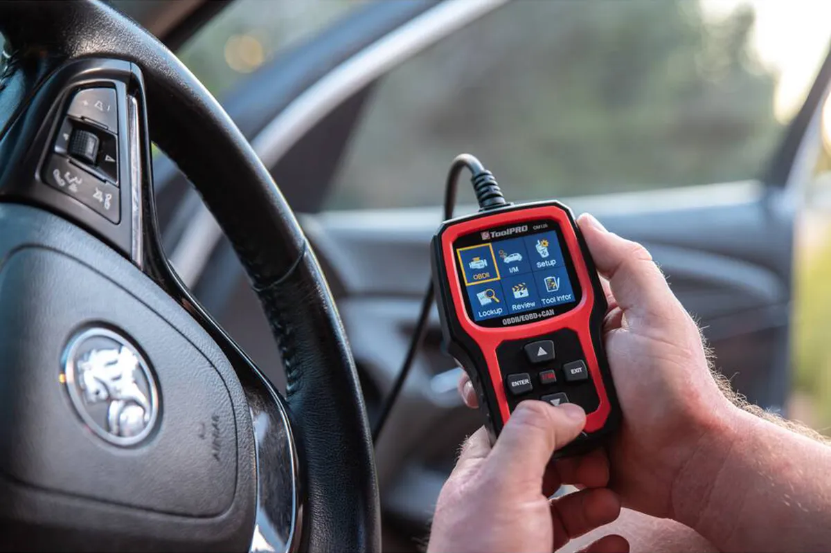 ToolPRO OBD2 and CAN scanner being operated next to a Holden steering wheel