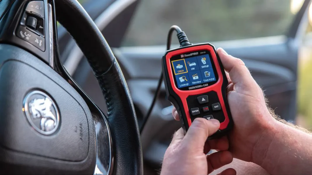 ToolPRO Auto Diagnostic Scanner showing its OBDII menu screen inside a vehicle