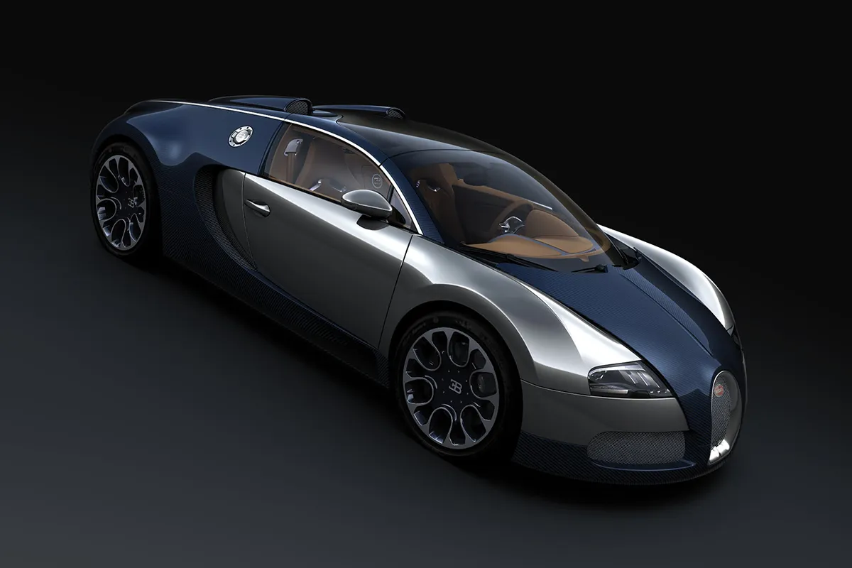 Bugatti Veyron Grand Sport Sang Bleu in studio from an elevated front three-quarter angle, blue-silver carbon fibre bodywork and polished alloy wheels against a dark background