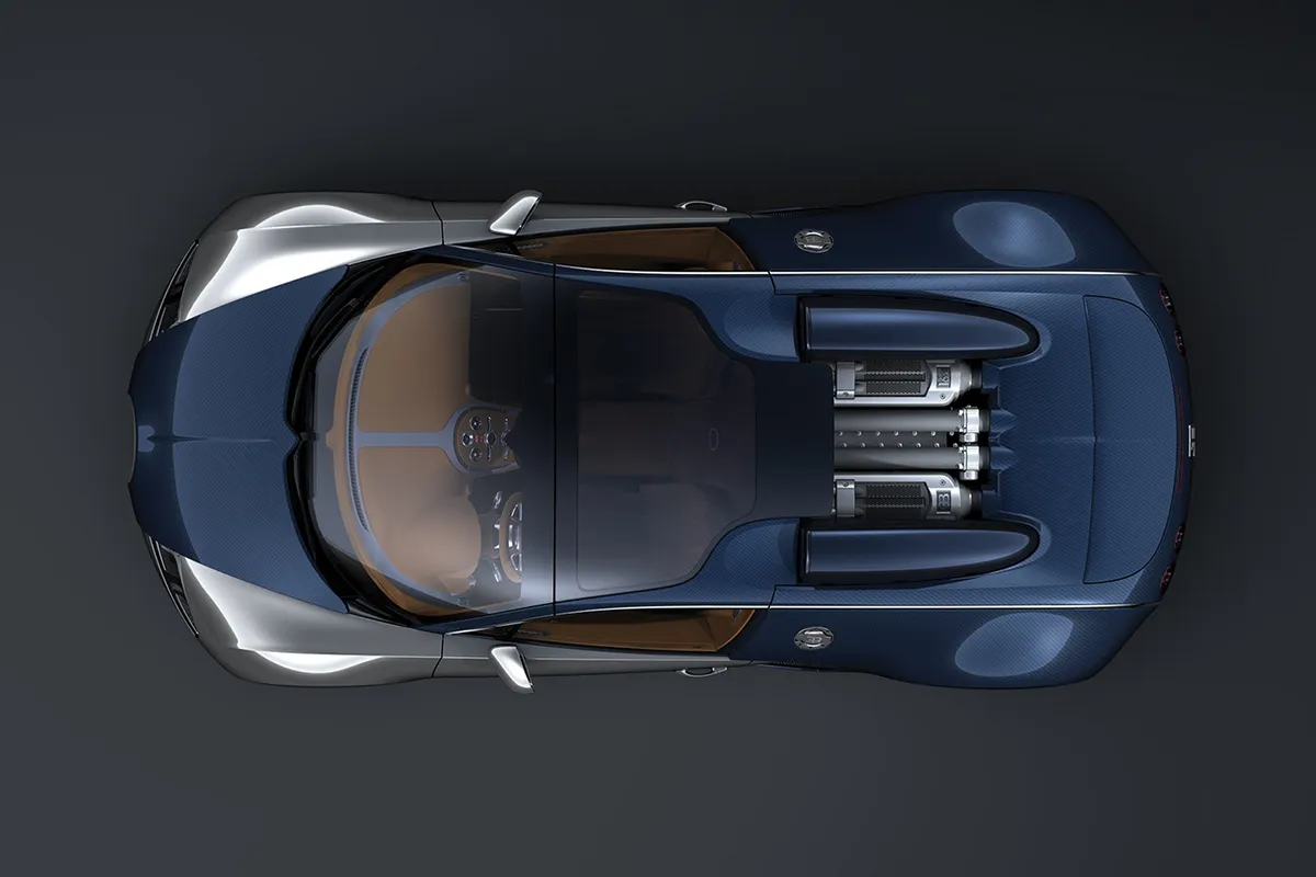 Bugatti Veyron Grand Sport Sang Bleu shot directly from above in studio, blue-silver carbon fibre bodywork with W16 engine visible through the rear glass panel