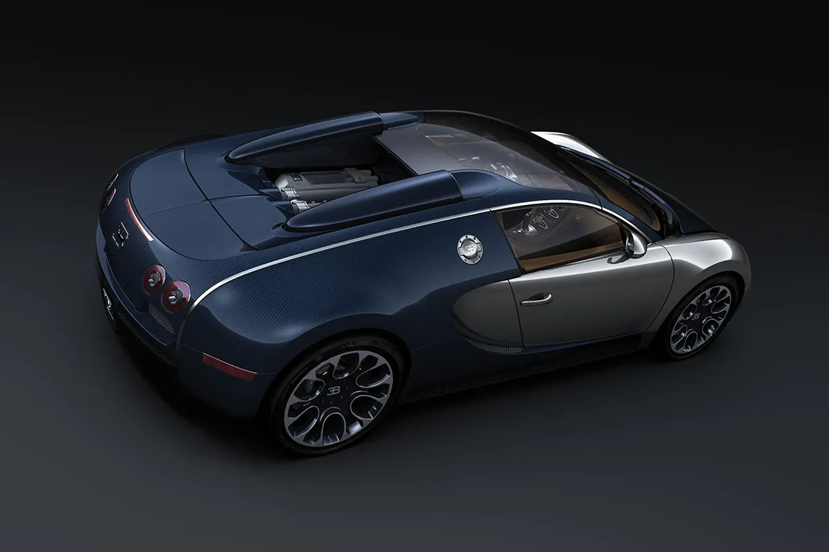 Bugatti Veyron Grand Sport Sang Bleu from an elevated rear three-quarter angle in studio, blue carbon fibre roof panel open revealing the W16 engine, dark background