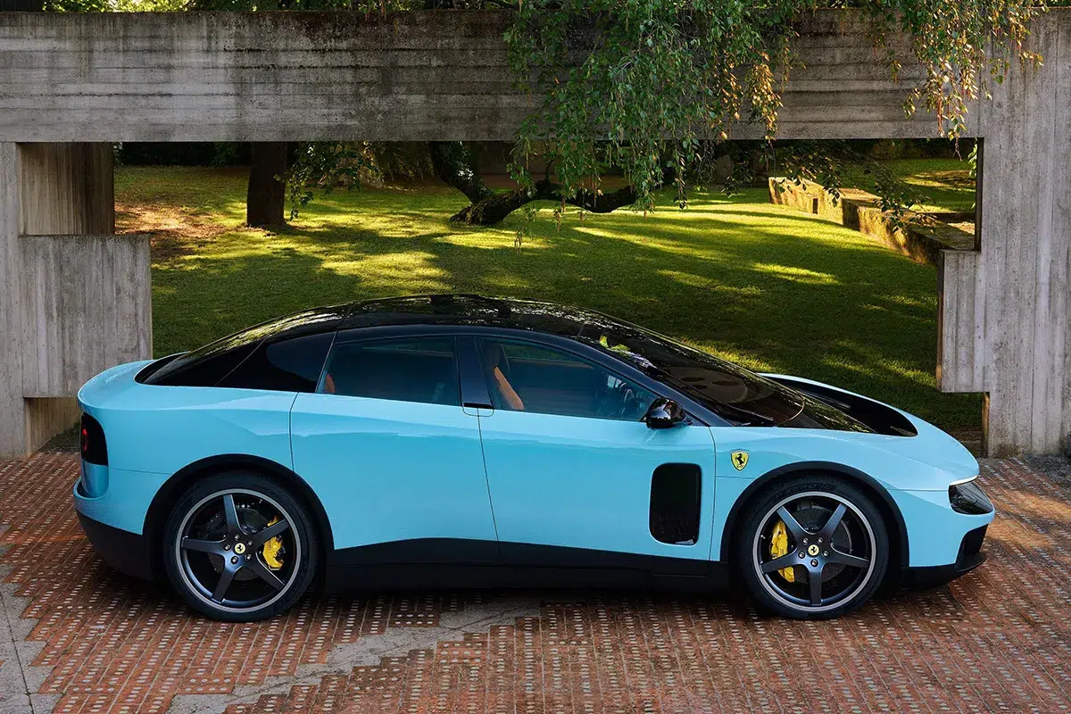 Ferrari Luce in light blue, clean side profile showing liftback roofline, coach door line, and staggered wheel sizes