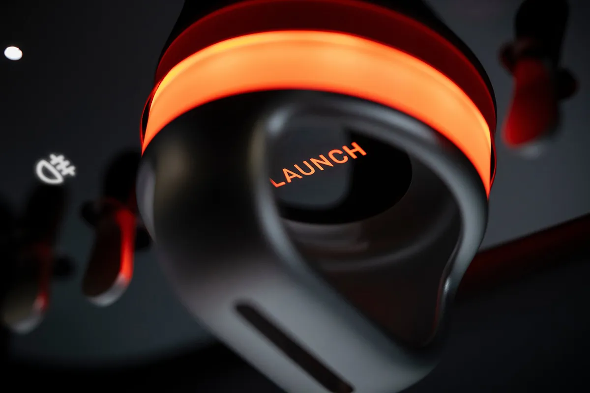 Ferrari Luce launch control lever illuminated in orange with LAUNCH text visible, helicopter-instrument-style design