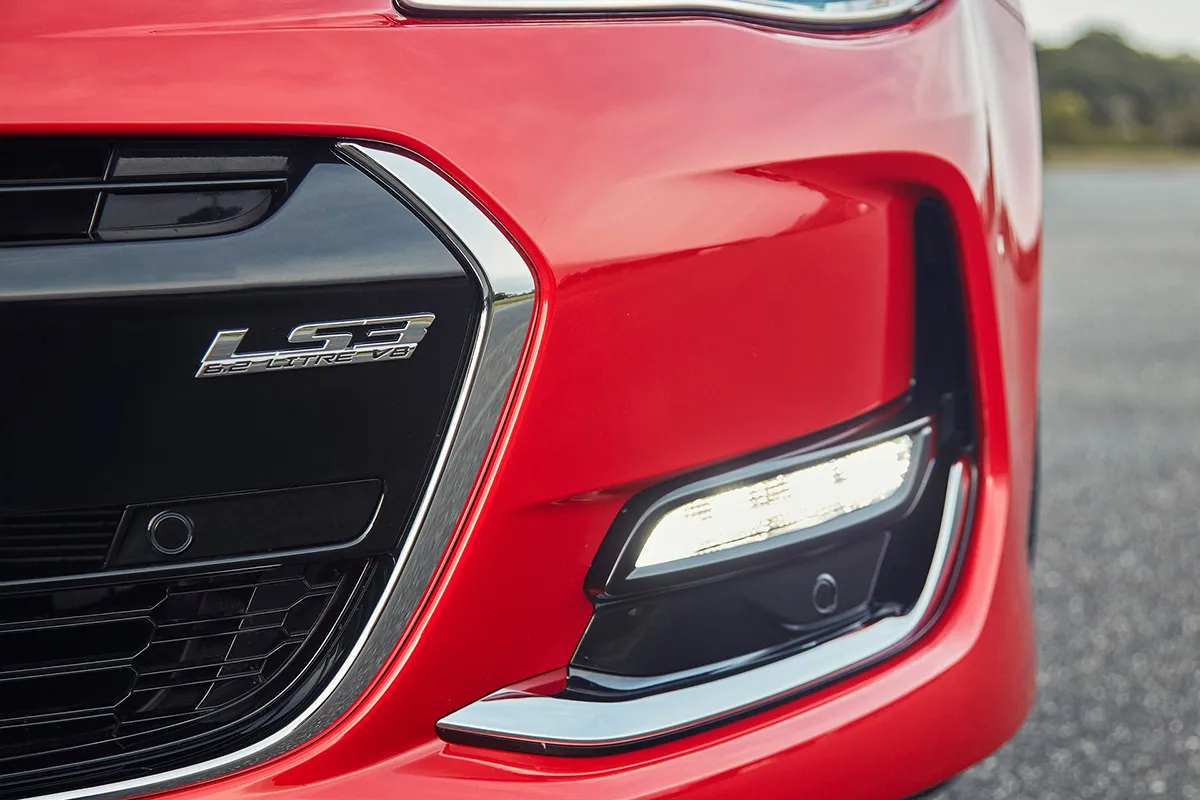 LS3 6.2 Litre V8 badge on the front grille of a red Holden VF Series II Commodore SS