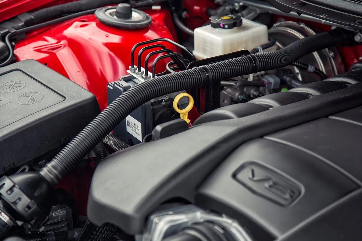 LS3 6.2-litre V8 engine bay of a red Holden VF Series II Commodore SS showing engine cover and bay detail