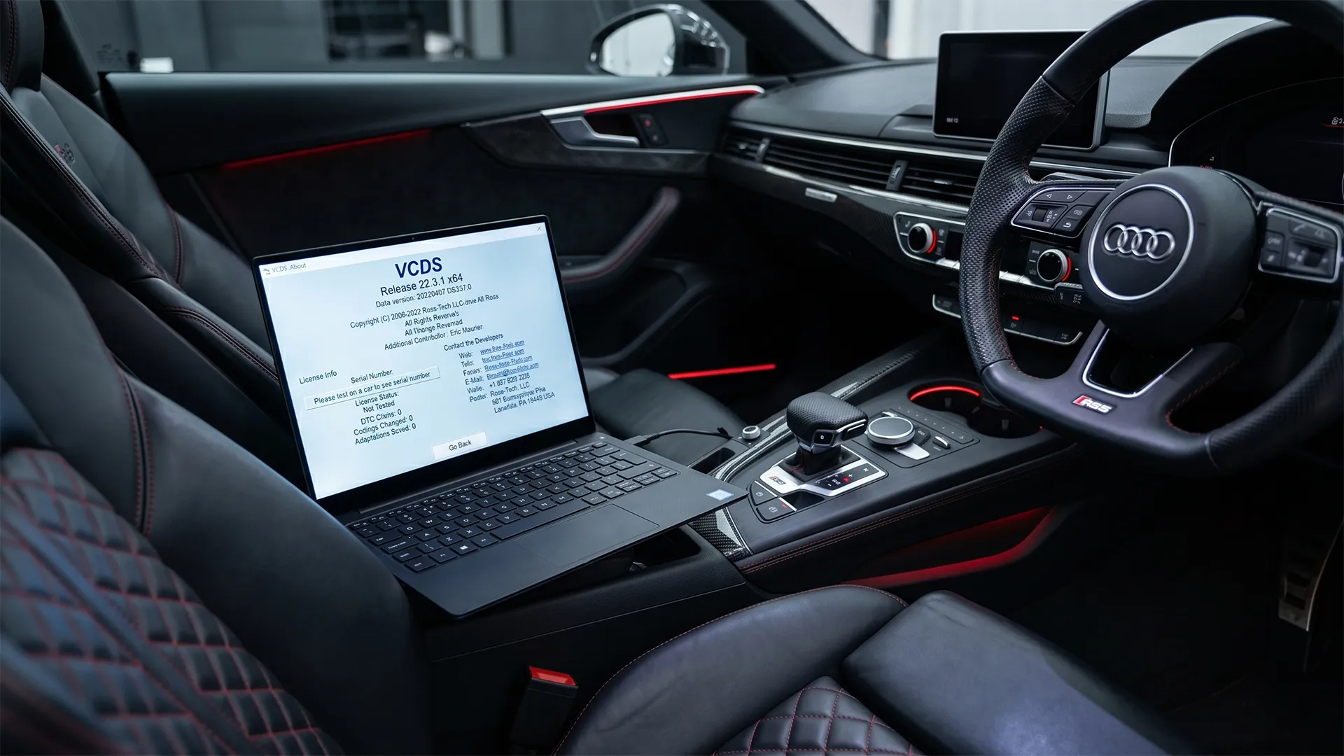 Laptop displaying VCDS diagnostic software version 22.3.1 resting on the centre console of an Audi RS5 interior