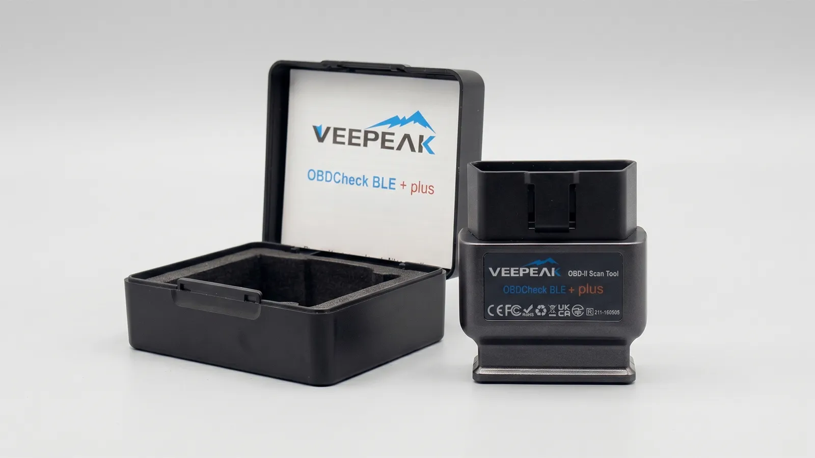 Veepeak OBDCheck BLE+ Bluetooth OBD2 scan tool beside its black storage case on a white background