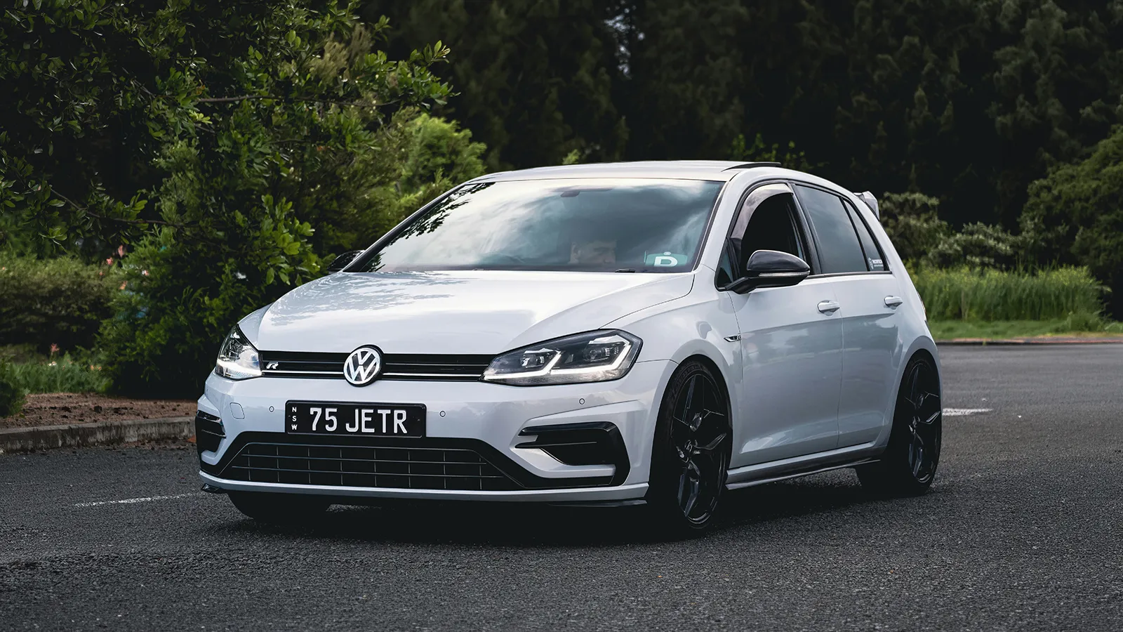 White Volkswagen Golf R on NSW number plates parked roadside, a high-output hatch off-limits to provisional drivers in the state