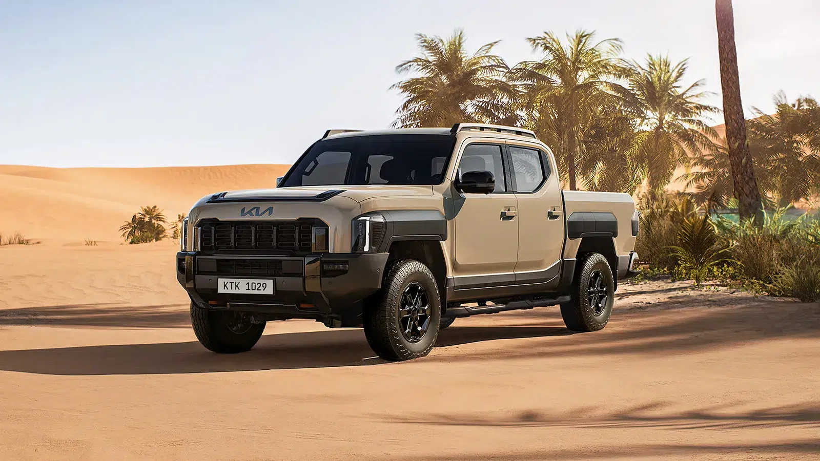 2026 Kia Tasman X-Pro parked in a desert oasis with sand dunes and palm trees in the background