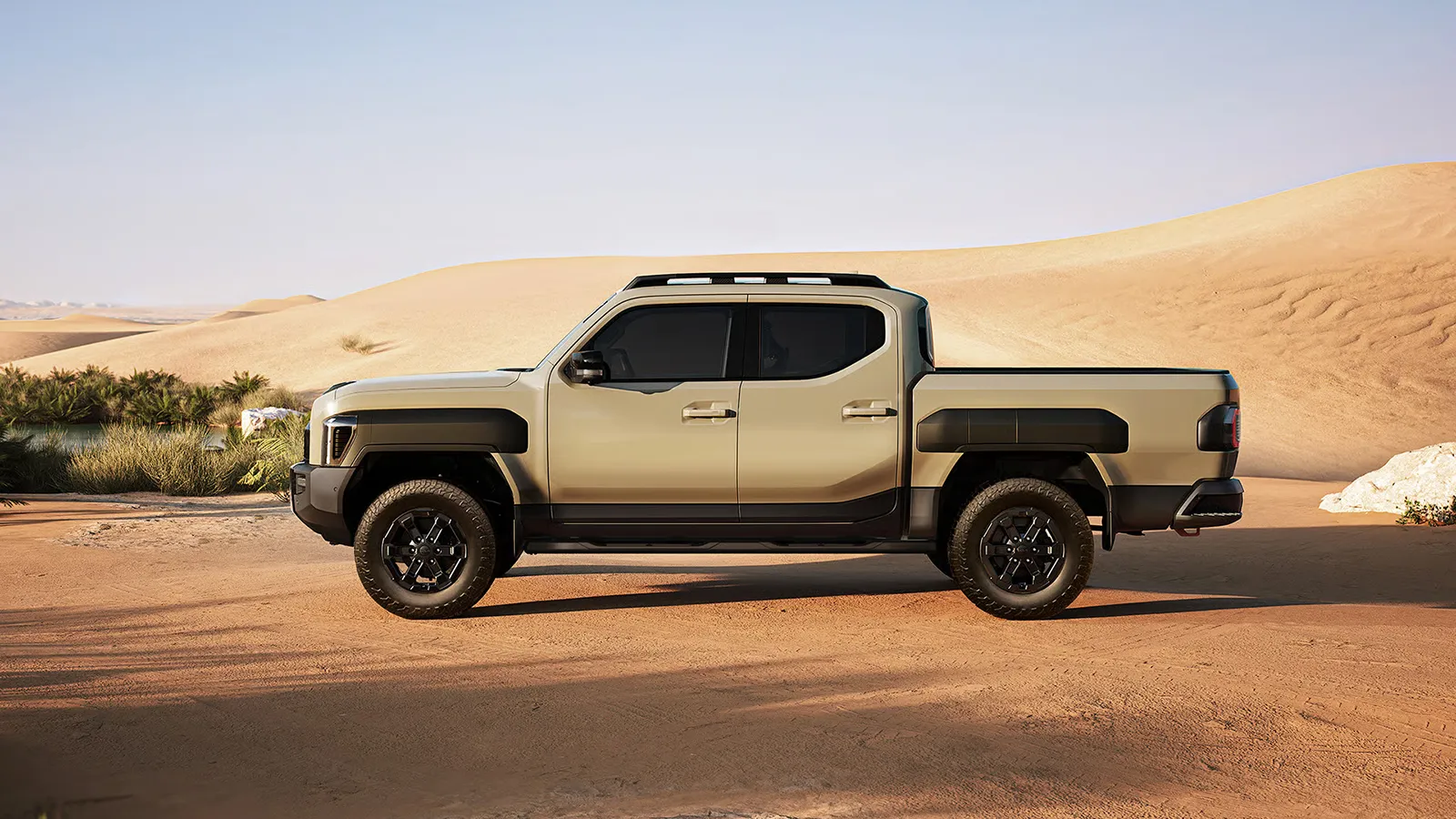Kia Tasman X-Pro side profile parked on a desert sand dune track
