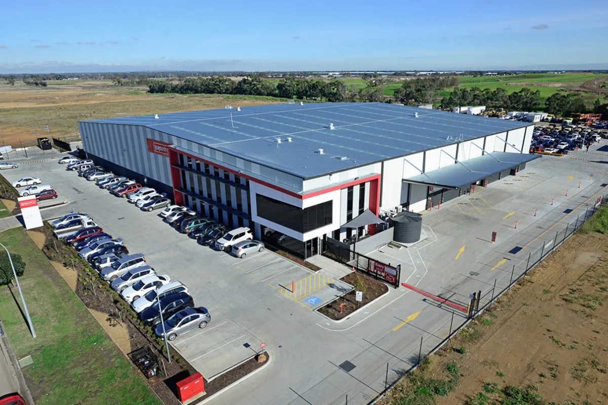 Aerial view of the Grays auction warehouse and car-filled inspection yard in outer-suburban Australia