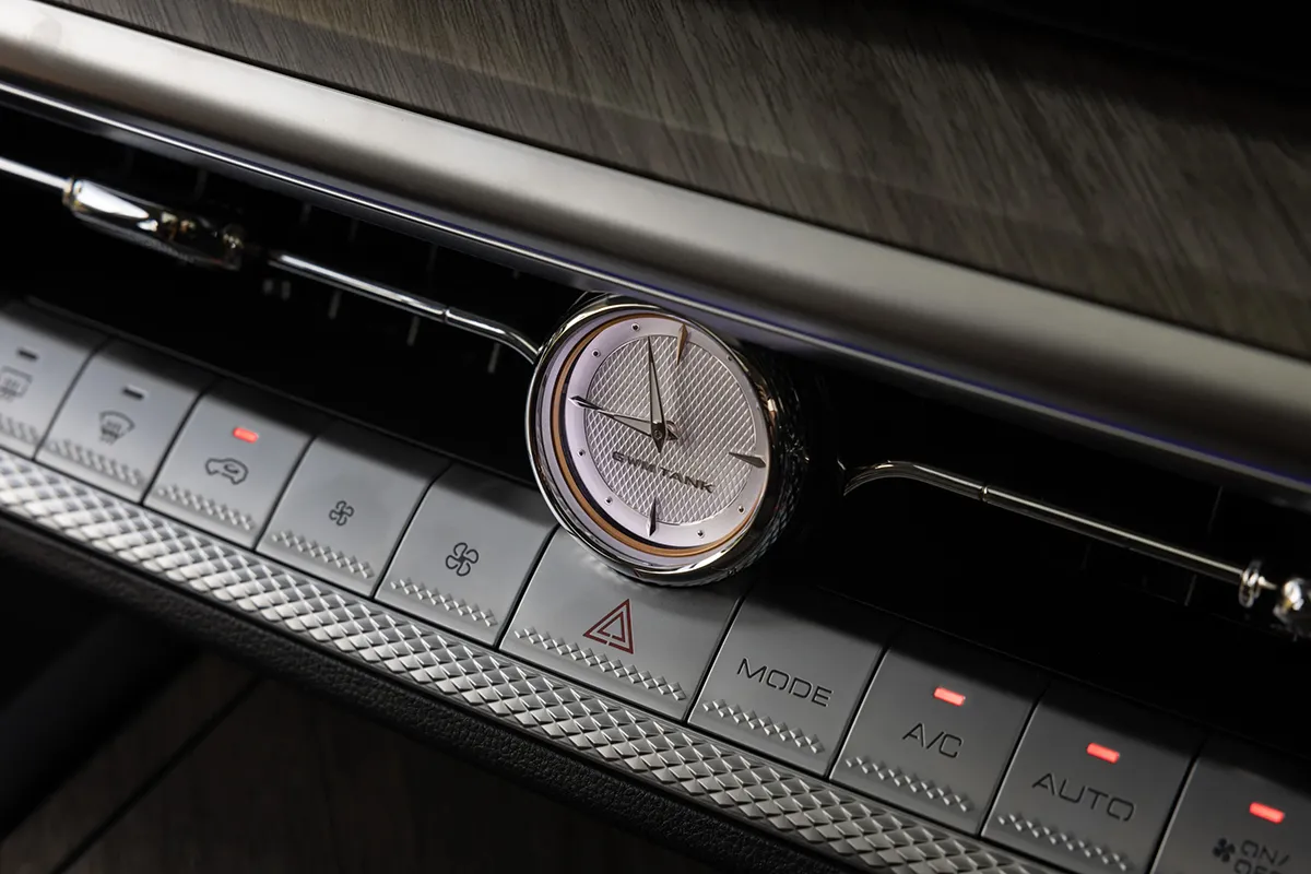 Close-up of the GWM Tank 500's analogue clock set into the centre dashboard console