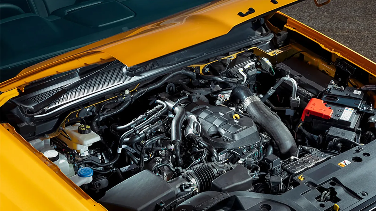 2023-Ford-Ranger-Wildtrak-X-engine Ford Ranger Wildtrak X engine bay with the bonnet raised, showing the covered four-cylinder diesel and intake plumbing
