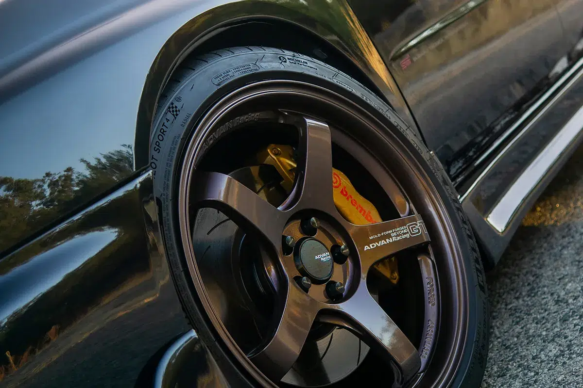 Bronze Advan Racing wheel with Michelin Pilot Sport tyre and yellow Brembo caliper on a lowered car