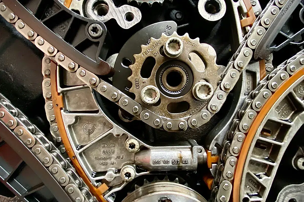 udi V6 timing chain drive stripped down showing multiple chains, sprockets, guide rails and tensioner