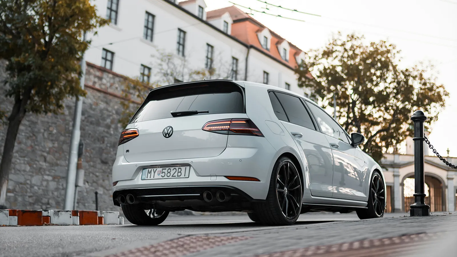 White Volkswagen Golf R Mk7.5 rear low-angle view showing quad exhaust outlets and diffuser
