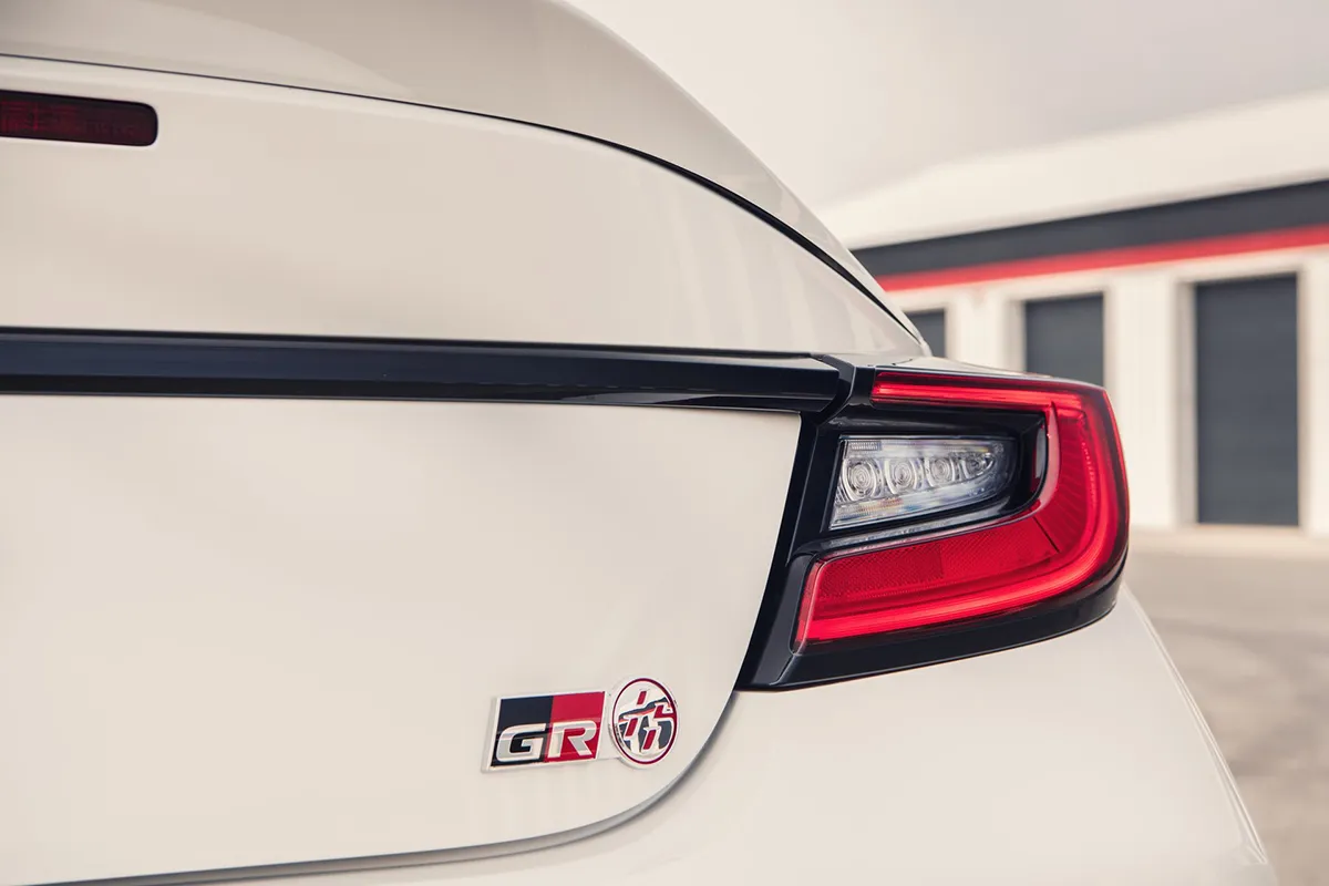 Rear detail of a cream Toyota GR86 showing the tail light and GR 86 badge