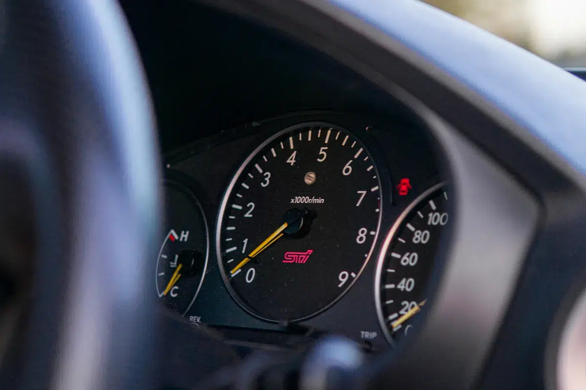 Close-up of a Subaru WRX STI instrument cluster showing the STI-branded tachometer