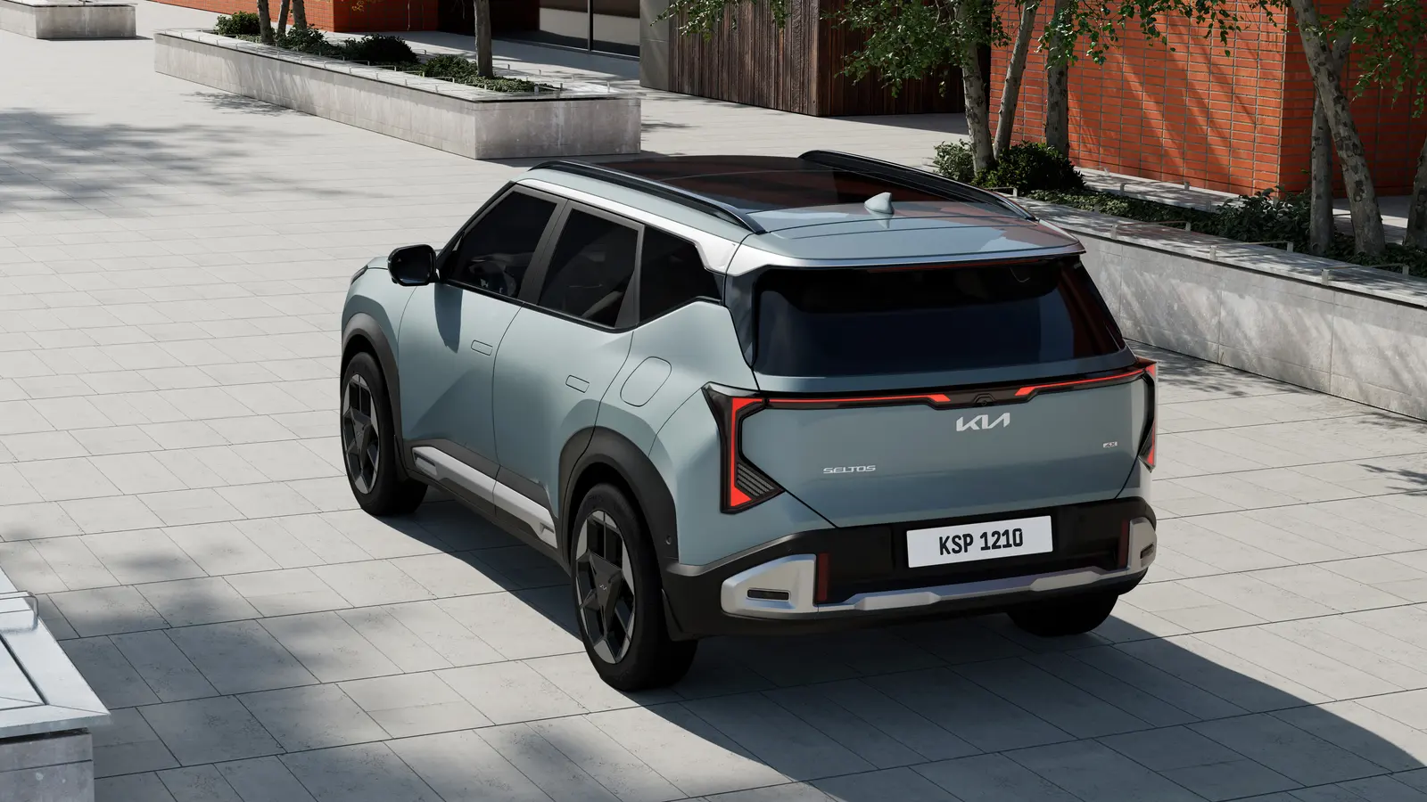 Rear three-quarter view of a light green 2027 Kia Seltos showing its vertical tail lights and roof rails