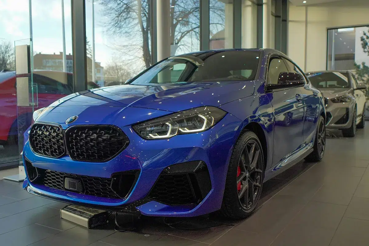 Blue-BMW-M235i-Gran-Coupe-dealership Blue BMW M235i Gran Coupe on display in a car dealership showroom