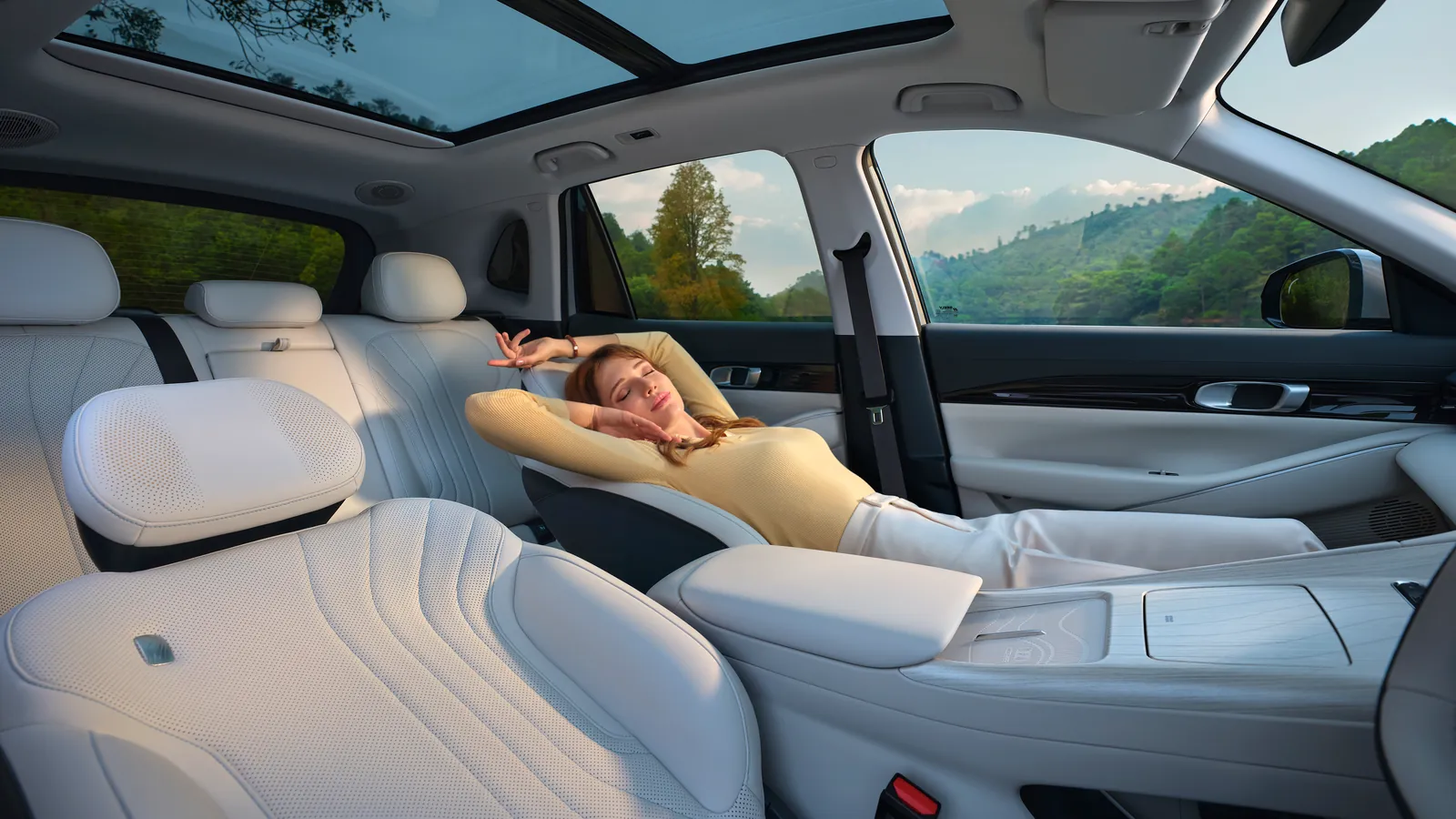Geely EX5 front passenger seat fully reclined with leg rest raised under the panoramic roof