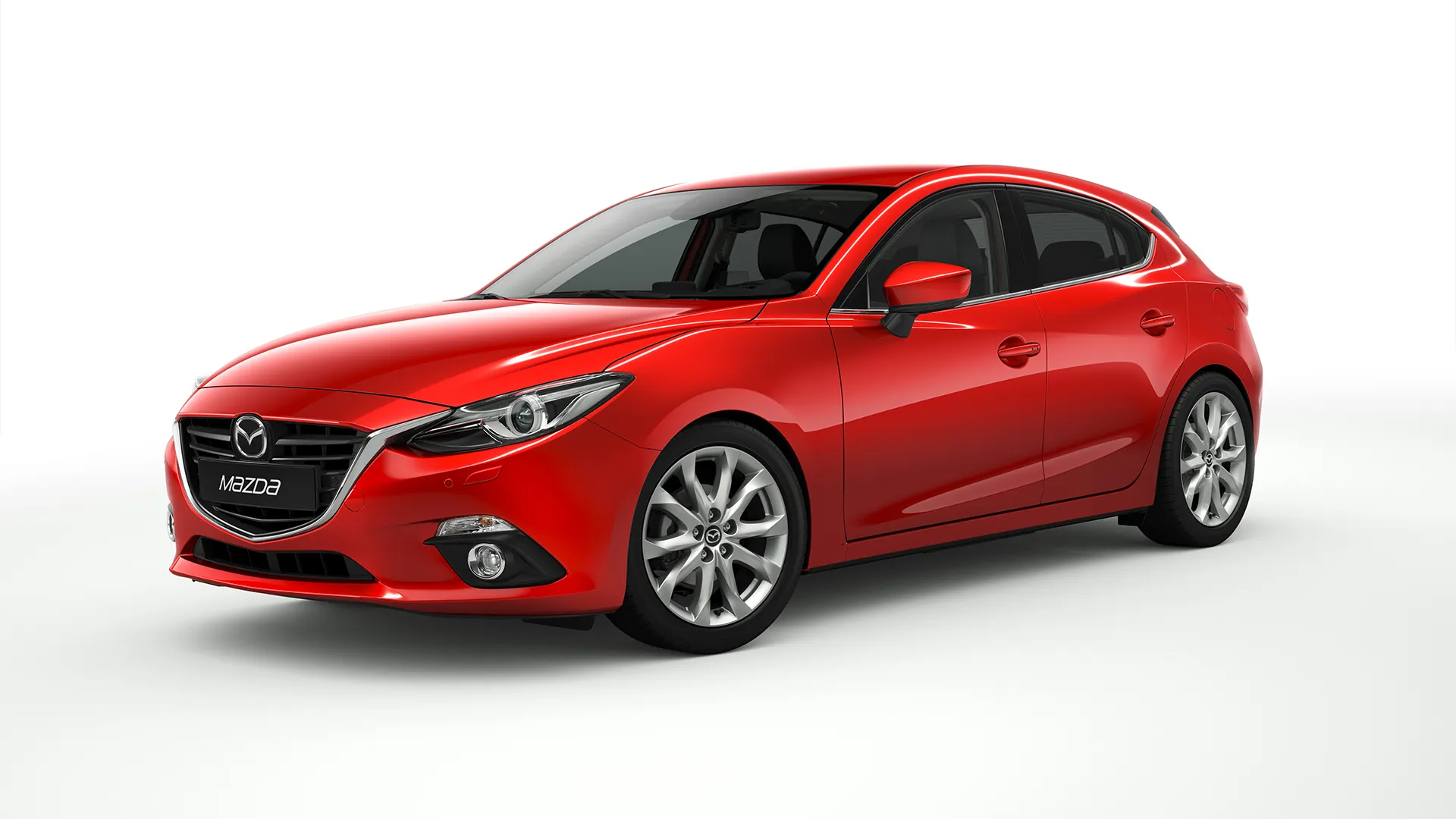 Red Mazda3 BM hatchback on a plain studio background, front three-quarter view showing alloy wheels