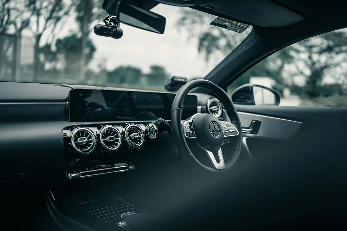 Interior of a Mercedes-Benz A-Class showing the dashboard, steering wheel and infotainment screen